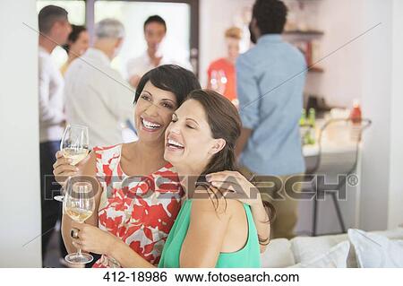 Women hugging at party View Large Photo Image Stock Photograph - Women hugging at party. Fotosearch