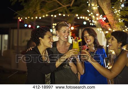 Women toasting each other at party View Large Photo Image Stock Photo - Women toasting each other at party. Fotosearch