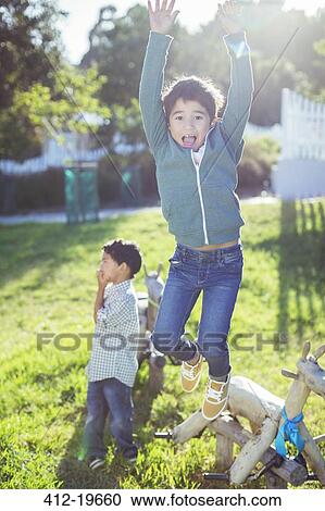 Stock Image - Boy jumping for joy outdoors. Fotosearch