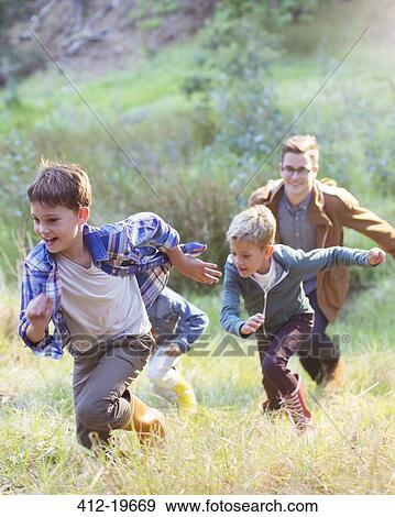 Boys running in field View Large Photo Image Stock Photo - Boys running in field. Fotosearch