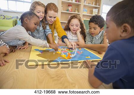 Children and teacher playing in class View Large Photo Image Stock Photo - Children and teacher playing in class. Fotosearch