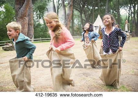 Children having sack race in field View Large Photo Image Stock Photography - Children having sack race in field. Fotosearch