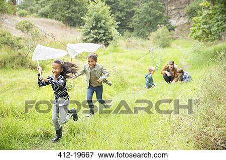 Children playing with butterfly nets on dirt path View Large Photo Image Stock Photo - Children playing with butterfly nets on dirt path. Fotosearch