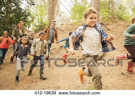 Stock Photo - Children running in forest. Fotosearch