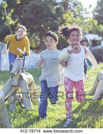 Picture - Children running on playground. Fotosearch