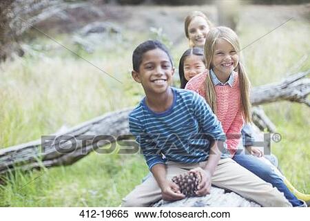 Children sitting on log in forest View Large Photo Image Stock Photography - Children sitting on log in forest. Fotosearch