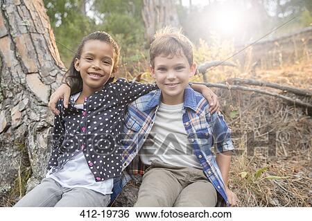 Children sitting together outdoors View Large Photo Image Stock Photograph - Children sitting together outdoors. Fotosearch