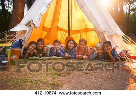 Children smiling in teepee at campsite View Large Photo Image Picture - Children smiling in teepee at campsite. Fotosearch