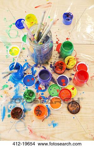 Jars of paint and paintbrushes on wooden table View Large Photo Image Picture - Jars of paint and paintbrushes on wooden table. Fotosearch