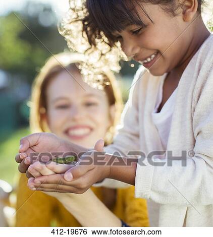 Mother and daughter examining insect View Large Photo Image Stock Photograph - Mother and daughter examining insect. Fotosearch