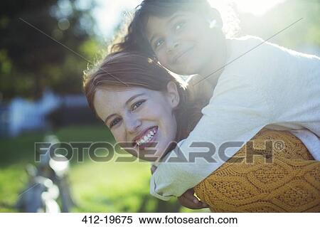 Mother carrying daughter on shoulders View Large Photo Image Stock Photography - Mother carrying daughter on shoulders. Fotosearch