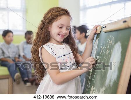 Student drawing on chalkboard in classroom View Large Photo Image Stock Photo - Student drawing on chalkboard in classroom. Fotosearch