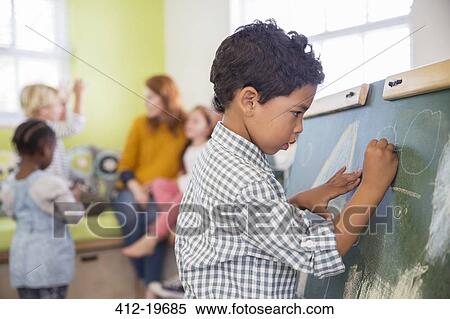 Student drawing on chalkboard in classroom View Large Photo Image Stock Photography - Student drawing on chalkboard in classroom. Fotosearch