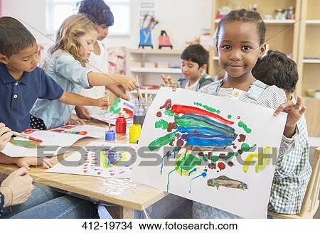 Student showing off finger painting in classroom View Large Photo Image Picture - Student showing off finger painting in classroom. Fotosearch