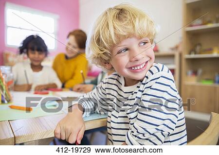 Student smiling in classroom View Large Photo Image Stock Photo - Student smiling in classroom. Fotosearch