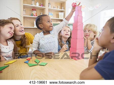 Stock Image - Student stacking blocks in class. Fotosearch