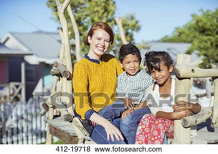 Stock Photo - Students and teacher sitting outdoors. Fotosearch