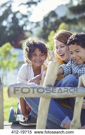 Stock Photography - Students and teacher sitting outdoors. Fotosearch