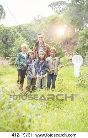 Students and teacher smiling in field View Large Photo Image Stock Image - Students and teacher smiling in field. Fotosearch