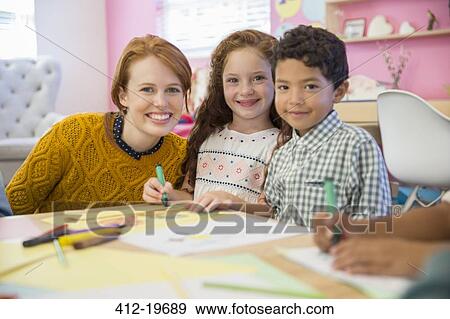 Stock Photo - Students and teacher smiling in classroom. Fotosearch