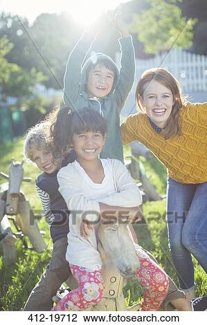 Stock Image - Students and teacher smiling outdoors. Fotosearch