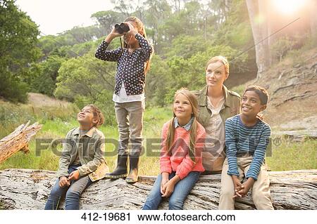 Students and teacher using binoculars in forest View Large Photo Image Stock Image - Students and teacher using binoculars in forest. Fotosearch