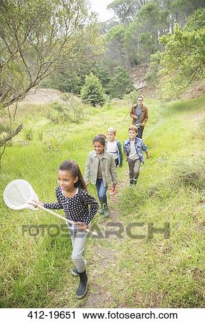 Students and teacher walking on dirt path View Large Photo Image Stock Image - Students and teacher walking on dirt path. Fotosearch