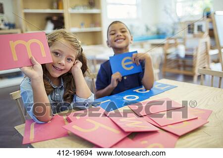 Picture - Students holding letters in classroom. Fotosearch