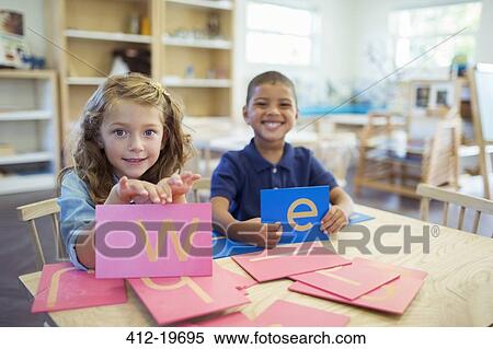 Students holding letters in classroom View Large Photo Image Stock Photography - Students holding letters in classroom. Fotosearch