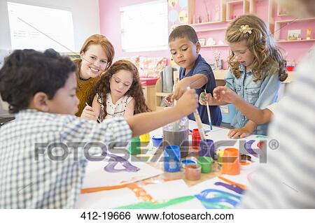 Stock Photograph - Students painting in class. Fotosearch