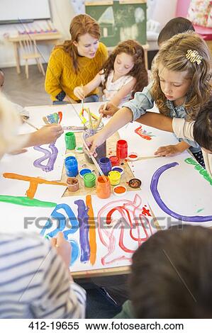 Stock Photography - Students painting in class. Fotosearch