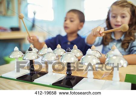 Stock Photo - Students playing bells in class. Fotosearch