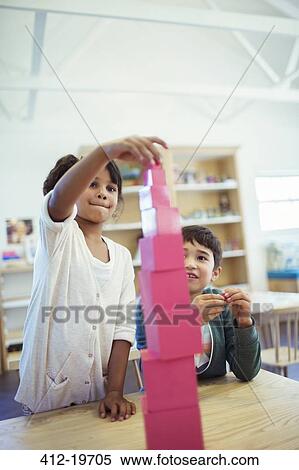 Students stacking blocks in classroom View Large Photo Image Stock Photography - Students stacking blocks in classroom. Fotosearch