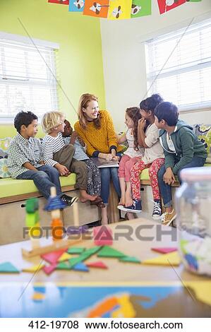 Teacher and students reading in classroom View Large Photo Image Stock Photo - Teacher and students reading in classroom. Fotosearch