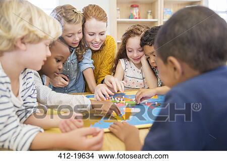 Picture - Teacher playing with students in classroom. Fotosearch