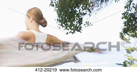 Stock Photo - Blurred view of woman walking outdoors. Fotosearch