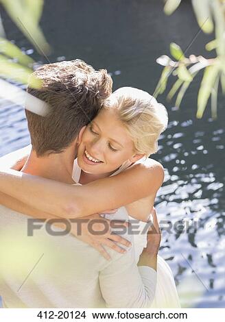 Couple hugging by pool View Large Photo Image Picture - Couple hugging by pool. Fotosearch