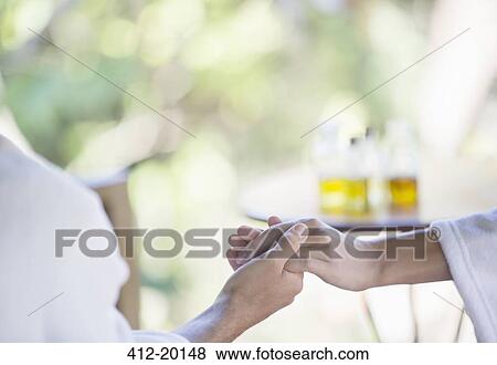 Couple in bathrobes holding hands in spa View Large Photo Image Stock Photo - Couple in bathrobes holding hands in spa. Fotosearch