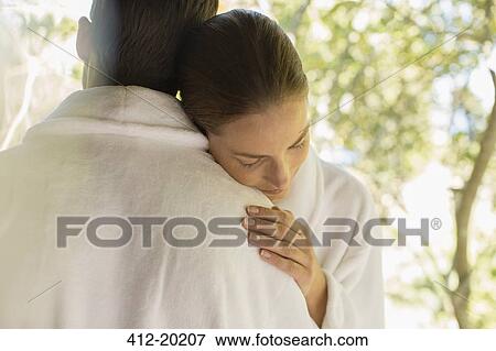Couple in bathrobes hugging View Large Photo Image Stock Photo - Couple in bathrobes hugging. Fotosearch