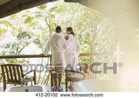 Couple in bathrobes standing in outdoor spa View Large Photo Image Stock Image - Couple in bathrobes standing in outdoor spa. Fotosearch