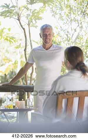 Stock Photograph - Couple relaxing together on balcony. Fotosearch