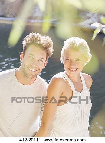 Couple sitting together by river View Large Photo Image Stock Image - Couple sitting together by river. Fotosearch
