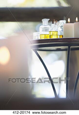 Essential oils and candles on table View Large Photo Image Picture - Essential oils and candles on table. Fotosearch