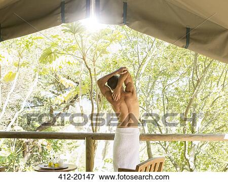 Man stretching in outdoor spa View Large Photo Image Stock Photo - Man stretching in outdoor spa. Fotosearch