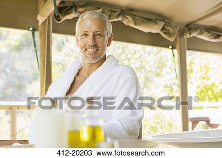 Man wearing bathrobe at table View Large Photo Image Stock Image - Man wearing bathrobe at table. Fotosearch