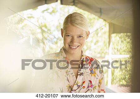 Stock Photo - Smiling woman wearing bathrobe. Fotosearch