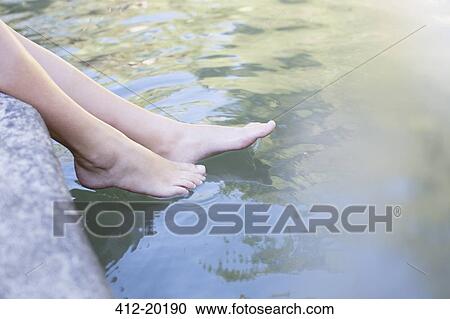 Woman dipping feet in pond View Large Photo Image Stock Image - Woman dipping feet in pond. Fotosearch