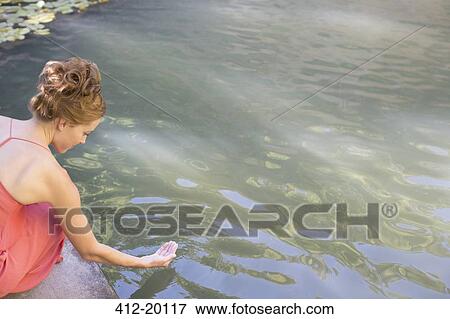 Woman dipping her hand in pool View Large Photo Image Stock Photo - Woman dipping her hand in pool. Fotosearch