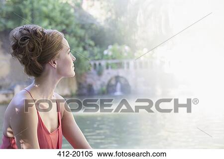 Woman overlooking bridge and river View Large Photo Image Stock Photography - Woman overlooking bridge and river. Fotosearch