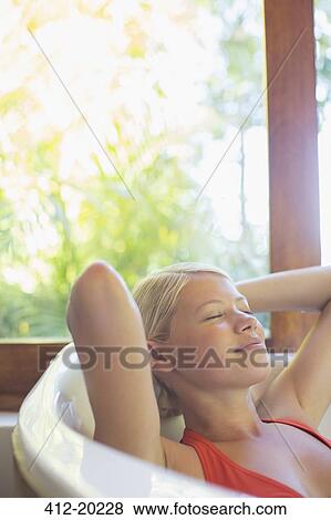 Stock Photo - Woman relaxing in hot tub. Fotosearch